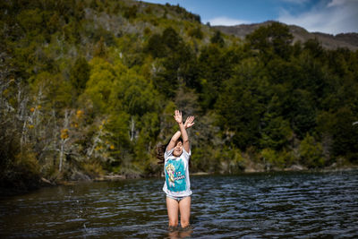 Rear view of young woman in water