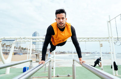 Man exercising on railing