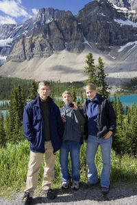 Full length of family standing against mountains at banff national park