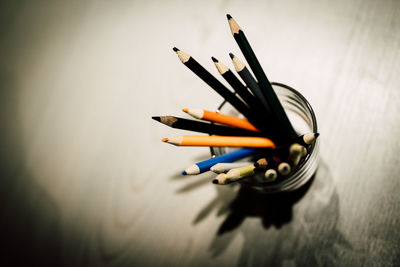 High angle view of colored pencils in jar on table