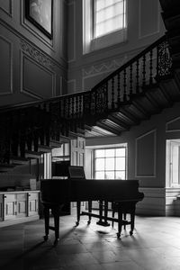 Piano against window at home