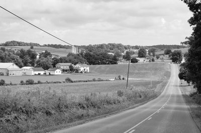 Empty road against cloudy sky