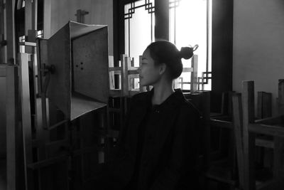 Portrait of young woman looking away at home