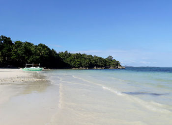 Scenic view of beach against clear sky