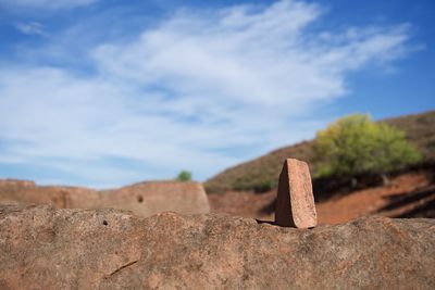 Close-up of rocks on rock against sky