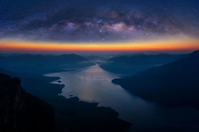 Scenic view of silhouette mountains against sky at night