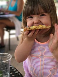Close-up of girl eating food