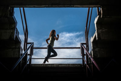 Low angle view of woman on staircase