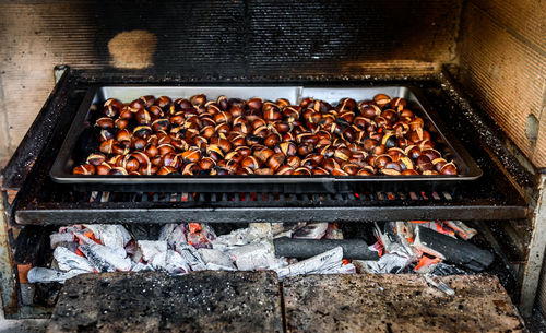 Food in tray on barbecue grill