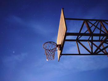 Nocturnal view of basketball post hoop