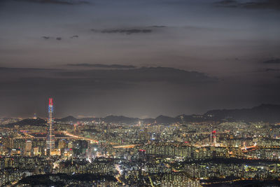 High angle view of city lit up at night