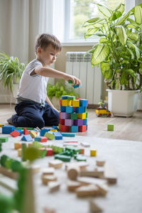 Boy playing with toy blocks on table