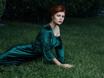 Portrait of beautiful young woman on field