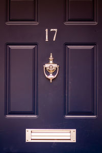 House number 17 on a blue wooden front door in london 