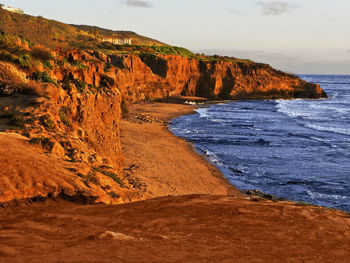 Scenic view of land and sea against sky