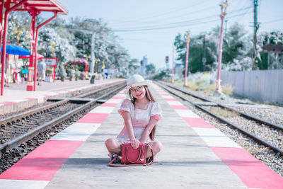 Full length portrait of woman at railroad station