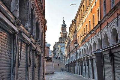 Street amidst buildings against sky