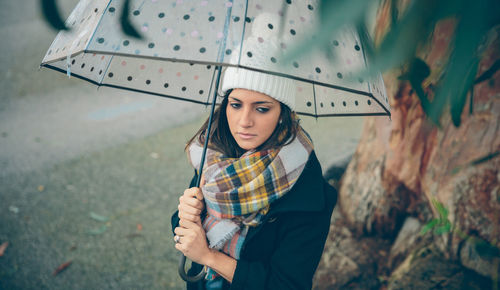 Portrait of young woman standing outdoors