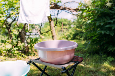 Hand washing clothes in a basin outside in summer