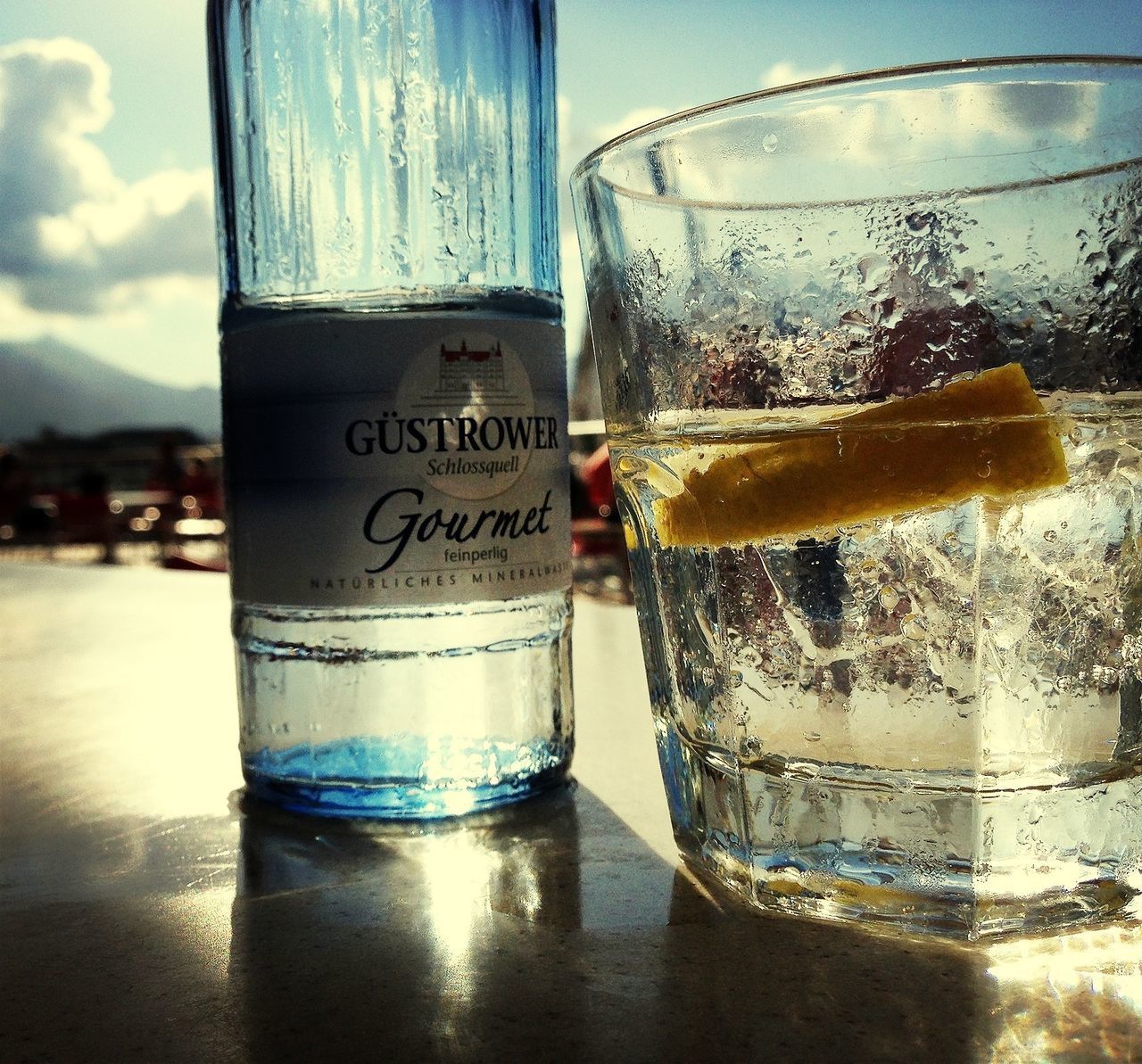 drink, refreshment, food and drink, freshness, drinking glass, close-up, water, table, glass - material, text, transparent, focus on foreground, alcohol, cold temperature, still life, indoors, ice, sky, western script, glass