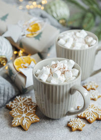 Hot chocolate with marshmallows, warm cozy christmas drink, gingerbread cookies and decorations