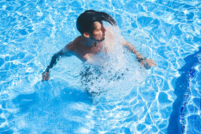 High angle view of man swimming in pool