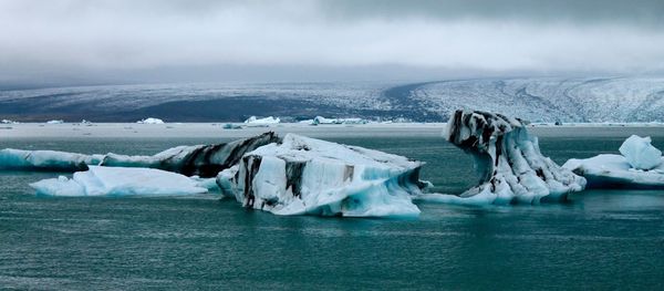 Scenic view of frozen sea against sky