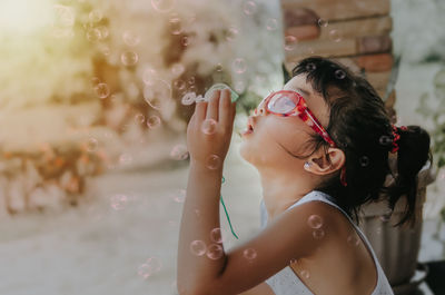 Cute girl blowing bubbles