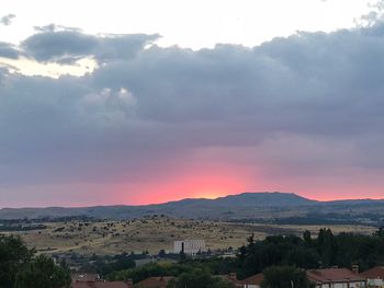 Scenic view of townscape against sky during sunset