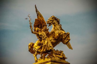 Low angle view of statue against sky