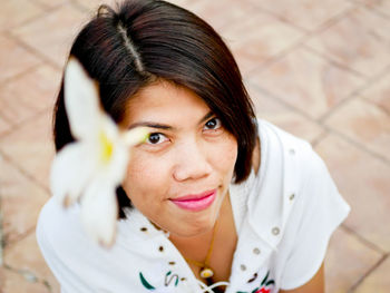 Portrait of woman on footpath