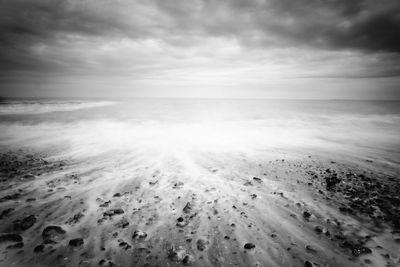 Scenic view of sea against cloudy sky