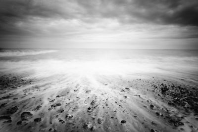 Scenic view of sea against cloudy sky