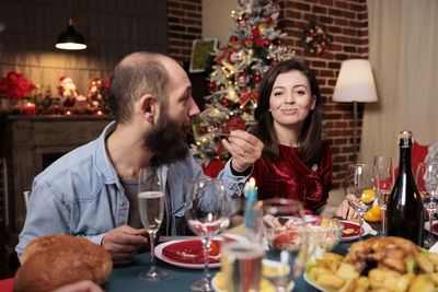 Portrait of smiling young woman having food at home