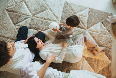 High angle view of family relaxing at home