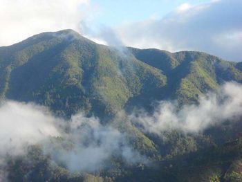 Scenic view of mountains against cloudy sky