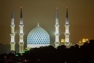 Panoramic view of illuminated buildings in city at night