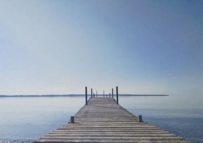 Pier over sea against clear sky