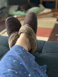 Low section of woman in shoes sitting at home