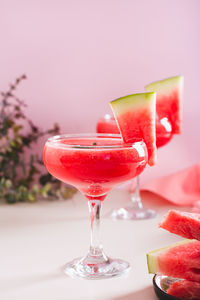 Refreshing watermelon cocktail with mint in glasses on the table vertical view