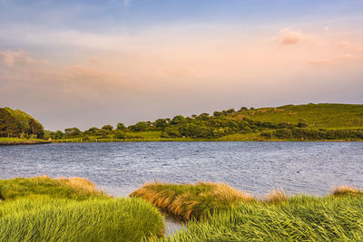Scenic view of lake against sky during sunset