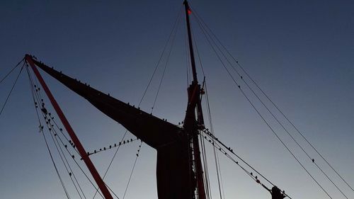 Low angle view of sailboat against clear sky