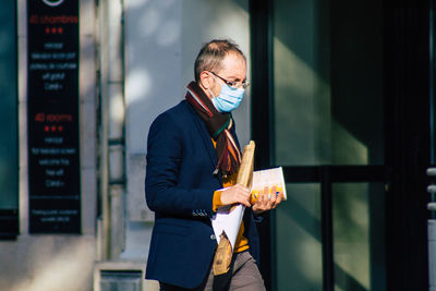 Full length of a young man using mobile phone