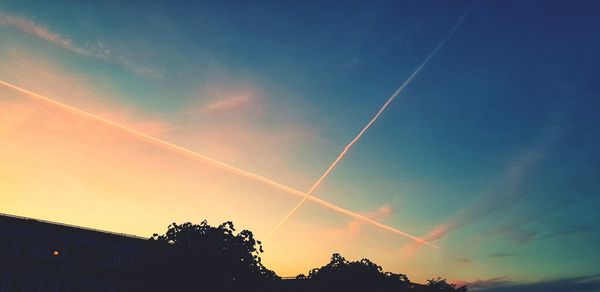 Low angle view of vapor trails in sky