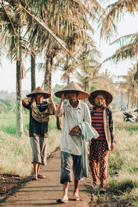 Group of people standing by tree