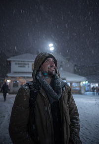 Portrait of young woman standing in snow
