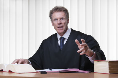 Portrait of a man sitting on table