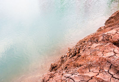 Close-up of rock formation by lake