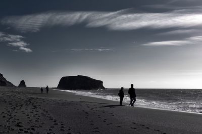 Silhouette people at beach