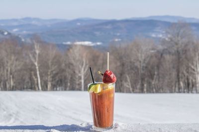 Close-up of drink with ice cream in background